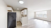 Located on West Blvd in Hartford, CT, this one-bedroom, one-bathroom unit offers a practical and well-appointed single-floor layout. Light wood-style flooring runs throughout the space, lending a clean, cohesive look to every room.

The combined kitchen and dining area is efficiently designed, featuring white cabinetry, a stainless steel sink, and appliances including a refrigerator and range. Flush-mount ceiling lighting illuminates the space, which flows naturally into the adjoining living room. The living room is bright and airy, benefiting from a large multi-pane window that fills the room with natural light, complemented by baseboard heating along the perimeter.

The bedroom is a comfortable, well-proportioned room with its own window offering outdoor views and ample natural light. It includes a louvered double-door closet and an additional closet, providing generous storage. Neutral warm-beige walls throughout the unit create a calm and inviting atmosphere.

The bathroom is clean and functional, featuring a full tub-shower combination with a white surround and built-in shelving, along with a toilet. A hallway connects the main living areas and provides access to additional closet storage, further enhancing the unit's practical appeal.