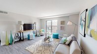 This single-floor residence at Park Plaza offers a thoughtfully designed open-concept layout finished with durable wood-style flooring throughout. The living area is generously proportioned, featuring neutral grey walls and a large sliding glass door that opens onto a private balcony, allowing natural light to fill the space and providing views of the surrounding cityscape. The living room flows seamlessly into a secondary seating or flex area, offering versatile functionality.

The kitchen is well-equipped with white shaker-style cabinetry, a double stainless steel sink, light laminate countertops, and a full suite of stainless steel appliances, including a range, over-the-range microwave, and refrigerator. Recessed lighting and a practical galley-style configuration make the kitchen both functional and bright.

The unit includes two bedrooms, each featuring wood-style flooring, neutral painted walls, and windows that frame outdoor views. Both rooms offer a calm, restful atmosphere with ample space for furnishings.

The full bathroom includes a tub-shower combination, a white vanity with stone-style countertop, and wood-style flooring, maintaining the cohesive modern aesthetic found throughout the unit. The overall ambiance is clean, contemporary, and move-in ready.