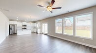 Located at 3940 Fence Rd NE in Auburn, GA, this two-story home offers four bedrooms and four bathrooms across a well-designed layout spread over two floors. The main level features an open-concept living, dining, and kitchen area bathed in natural light from large windows that frame views of the backyard. The living room is anchored by a classic fireplace and ceiling fan, with smooth hardwood-style flooring throughout. The kitchen is appointed with white shaker cabinets, granite countertops, a subway tile backsplash, stainless steel appliances, and a central island — all complemented by a dedicated pantry. A private office and a welcoming entrance complete the main level, along with an attached garage. Upstairs, the spacious primary bedroom includes a generous walk-in closet with wire shelving. Three additional bedrooms feature plush carpeting and natural light. A dedicated laundry room with washer and dryer hookups adds everyday convenience. Four full bathrooms are distributed throughout the home. With neutral tones, clean finishes, and a functional floor plan, this home offers a comfortable and modern living experience in a residential Auburn neighborhood.