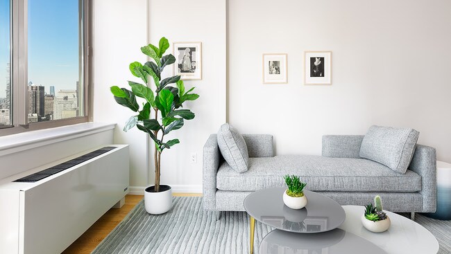 photo of 2 Gold St model apt 4904 pass-through kitchen and living room staged with modern curved furniture - 2 Gold St