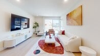 Located at 510 South Oxford Avenue in Los Angeles' vibrant Koreatown neighborhood, this thoughtfully designed 2-bedroom, 2-bathroom residence offers a clean, modern aesthetic throughout its well-appointed single floor. The open kitchen is a standout, featuring sleek grey cabinetry, a marble-veined quartz backsplash and countertops, stainless steel appliances including a high-end range with over-the-range microwave, a French door refrigerator, and a dishwasher — all combining style with functionality. The living room is bright and airy, with large sliding glass windows that frame city views and flood the space with natural light, creating an inviting atmosphere. Both bedrooms are generously proportioned, with the primary suite offering direct balcony access through full-height glass doors and ample natural light. The second bedroom also enjoys large windows with open city views. A dedicated walk-in closet provides excellent storage. The two bathrooms are finished with neutral tile flooring, grey vanities, quartz countertops, and large mirrors. A discreet in-unit laundry closet houses a stacked washer and dryer. Light wood-style flooring runs throughout, tying the space together with a cohesive, contemporary feel.