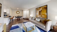 Located at Waterside View Drive in Reston, Virginia, this two-bedroom, one-bathroom residence offers a thoughtfully designed single-floor layout that maximizes every inch of its compact footprint. The open-concept living and dining area forms the heart of the home, finished with rich hardwood-style flooring throughout. The living space is anchored by French doors that invite natural light and provide direct outdoor access, creating an airy, connected feel. A dedicated dining nook with recessed lighting and chair-rail detailing complements the living area seamlessly.

The kitchen features white shaker cabinetry, dark granite countertops, and a full suite of stainless steel appliances, including a refrigerator, range, built-in microwave, and dishwasher. The primary bedroom is generously proportioned, offering a double closet and plush carpeting, while a walk-in style closet provides additional storage. The full bathroom is clean and functional, featuring a tub-shower combination with hardwood-style flooring and a white vanity. Neutral tones and consistent finishes throughout give the residence a cohesive and well-maintained character.