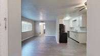 Located at 765 McMurray Drive in Nashville, TN, this two-bedroom, one-bathroom single-floor home offers a functional and well-appointed layout. The open living and kitchen area serves as the heart of the home, featuring wood-look hard surface flooring, neutral-toned walls, and a ceiling fan. Natural light flows in through horizontal-blind-fitted windows, creating a bright and welcoming atmosphere. The galley-style kitchen is thoughtfully designed with crisp white cabinetry, granite countertops, a classic subway tile backsplash, a stainless steel sink, and black appliances including a range, microwave, refrigerator, and dishwasher. The full bathroom is finished with a white vanity topped with granite counters, a large mirror, and a tub-shower combination. The spacious primary bedroom features wood-look flooring and generous window coverage for ample natural light. The second bedroom is carpeted for added comfort and includes a closet with built-in shelving for organized storage. Both bedrooms offer a quiet, private feel. A connecting hallway links the bedrooms and bathroom efficiently. Throughout the home, clean finishes, consistent flooring choices, and updated fixtures give the space a cohesive, move-in-ready appeal.