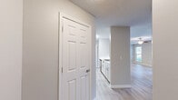 Located at 1000 Arbor Keats Dr in Simpsonville, SC, this 2-bedroom, 2-bathroom single-floor residence offers a thoughtfully designed layout with consistent, modern finishes throughout. The open living area is bright and welcoming, featuring light wood-look flooring, neutral gray walls, a textured ceiling, and a ceiling fan. French doors lead to an outdoor patio, allowing natural light to fill the space. The kitchen is well-equipped with white cabinetry, stainless steel appliances including a refrigerator, range, and microwave, and a marble-look countertop that extends to a breakfast bar — ideal for casual dining. The primary bedroom is generously sized with a ceiling fan, a window with outdoor views, and direct access to its own full bathroom. The second bedroom also features wood-look flooring, a ceiling fan, and a walk-in closet. Both bathrooms are finished with white vanities, marble-look countertops, wood-look tile flooring, and tub-shower combinations. A dedicated laundry area accommodates a full-size washer and dryer with overhead shelving for added storage. The unit's cohesive design, practical layout, and functional amenities make it a comfortable and move-in-ready residence.