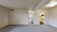 Located at 993 Richmond Ct in Kalamazoo, Michigan, this single-floor unit offers a practical and well-organized layout designed for comfortable everyday living. The open living area is finished with wall-to-wall carpet and neutral cream-toned walls, creating a clean and inviting atmosphere. Textured ceilings throughout add a classic character to the space. A central hallway connects the main living area to the rest of the unit, providing a logical flow between rooms. The galley-style kitchen is efficiently arranged with white cabinetry featuring wood-tone trim, white appliances including a range and refrigerator, a dishwasher, and a double sink. The kitchen is finished with durable wood-look flooring, providing a practical contrast to the carpeted areas. The bedrooms are generously proportioned, each featuring soft carpet, neutral walls, and windows that bring in natural light. One bedroom includes a louvered closet door, while another offers a large window with vertical blinds, enhancing the sense of openness. The bathroom is clean and functional, featuring a full tub-shower combination with white surround and chrome fixtures. Overall, the unit presents a straightforward, well-maintained living environment in a residential Kalamazoo neighborhood.