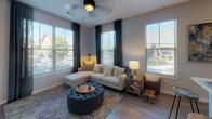 This well-appointed single-floor residence at 1001 Archdale Dr in Franklin, Tennessee offers a thoughtfully designed layout with modern finishes throughout. The open-concept kitchen is a standout feature, showcasing dark cabinetry, stainless steel appliances, a large island with a white quartz countertop and bar seating, pendant lighting, and wood-look flooring—all bathed in natural light from multiple windows. The kitchen flows seamlessly into the living area, where a ceiling fan, large windows with teal drape accents, and wood-look flooring create a bright, welcoming atmosphere. A dedicated dining room features wood-look floors, natural light, and tasteful décor, offering an ideal space for gatherings. Both bedrooms are carpeted for comfort, featuring generous windows with views to the outdoors and ample room for furnishings. The two bathrooms are consistently finished with dark vanity cabinetry, white countertops, wood-look tile flooring, and tiled tub-shower combinations. A dedicated laundry room with a full-size washer and dryer and overhead shelving adds everyday convenience. The overall aesthetic is contemporary and cohesive, with neutral tones, quality finishes, and an abundance of natural light throughout.