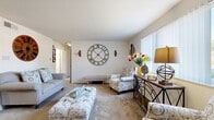 This thoughtfully designed single-floor home offers a practical and comfortable layout across two bedrooms, one bathroom, and a collection of well-defined living spaces. The carpeted living room is bright and welcoming, featuring large windows that allow natural light to fill the room, neutral white walls, and generous space for seating arrangements. The open feel of the living area flows naturally into the dining room, creating an ideal setting for everyday living and entertaining. The kitchen is equipped with warm wood cabinetry, a tile backsplash, solid countertops, and a stainless steel sink, offering a functional workspace with ample storage. The primary bedroom is a comfortable retreat, featuring carpet flooring, a window with natural light, and dual closets with built-in shelving and hanging rods for well-organized storage. The second bedroom also features carpet and a window, providing a versatile space. The full bathroom includes warm wood vanity cabinetry, a white countertop, and a shower/tub combination. With three closets distributed throughout the home, storage is plentiful. The hallway connects all areas efficiently, contributing to the home's practical and cohesive single-level flow.