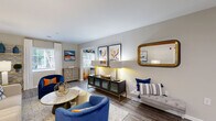 Located at 4048 Battleground Ave in Greensboro, NC, this single-floor residence offers a thoughtfully designed layout with 2 bedrooms, 2 bathrooms, an office, and a dedicated laundry room. The open-concept living, dining, and kitchen area serves as the heart of the home, featuring durable wood-look flooring, neutral walls, and multiple windows that bring in generous natural light. The kitchen stands out with white shaker cabinetry, granite countertops, a peninsula with a sink, and stainless steel appliances, opening directly to the dining nook for seamless entertaining. The living room provides a spacious, welcoming atmosphere with room for ample seating arrangements. The primary bedroom features plush carpet, a ceiling fan, and a window overlooking the outdoors, offering a comfortable retreat. The second bedroom and a separate office provide flexible options for guests or working from home. Both bathrooms are functional and clean, with one featuring a full tub-shower combination. Two closets offer practical storage throughout. The hallway connects all spaces efficiently, contributing to a cohesive and organized floor plan. Overall, this residence delivers a comfortable, functional living environment with modern finishes in a convenient Greensboro location.
