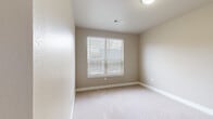 Located in Golden, Colorado, this well-appointed single-floor home offers three bedrooms, two bathrooms, and a thoughtfully designed layout. The living room features warm hardwood flooring, neutral walls, and large windows fitted with blinds that allow natural light to fill the space, along with a door providing exterior access. The kitchen is a standout, showcasing rich dark wood cabinetry, a large center island with a white countertop, stainless steel appliances, and pendant lighting — all complemented by the same hardwood flooring that flows throughout the common areas. A stacked washer and dryer are conveniently tucked nearby. The hallway connects the main living areas to the bedrooms via stylish five-panel white doors and warm hardwood floors, with flush-mount ceiling lighting providing clear visibility throughout. Each bedroom features soft carpeting, neutral toned walls, and windows with blinds for natural light. The primary bedroom is generously proportioned and connects to a bathroom with large-format tile flooring, dark wood vanity cabinetry, open shelving for storage, and direct access to a walk-in closet with built-in shelving. Additional closets provide ample storage throughout the home. The overall aesthetic is clean, modern, and move-in ready.
