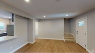 Located in Santa Rosa, CA, this two-floor property showcases a clean, contemporary design with a consistent palette of soft gray walls, bright white trim, and warm wood-look flooring throughout. The open-concept main living area is generously proportioned, with recessed lighting overhead and large windows that invite natural light and outdoor views. A pass-through counter connects the living space to a well-designed kitchen, which features gray shaker-style cabinetry, white quartz countertops, a subway tile backsplash, stainless steel appliances including a gas range, built-in microwave, dishwasher, and refrigerator, plus pendant lighting that adds a stylish finishing touch. Two bathrooms serve the property: one full bath with large-format tile, a soaking tub with a glass sliding door, a gray vanity with a white countertop, and a framed mirror; and a second bathroom with a matching gray vanity, medicine cabinet, and modern vanity lighting. The upper floor includes additional rooms with recessed lighting, wood-look flooring, and windows offering neighborhood views. A carpeted staircase connects the two levels. Throughout, the space presents a move-in ready condition with thoughtful, modern finishes.