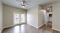 Located in El Paso, TX, this single-floor 4-bedroom, 2-bathroom home offers a thoughtfully designed layout that maximizes functionality and comfort. Wood-look flooring flows consistently throughout the home, lending a clean, cohesive aesthetic to every room.

The living room is bright and inviting, featuring French doors that open to an outdoor balcony area, allowing natural light to pour in. A ceiling fan adds comfort to the space. Adjacent to the living area, the dining room is elevated by a stylish multi-bulb chandelier and vaulted ceiling detail, creating an elegant setting for meals.

The kitchen is well-appointed with white shaker-style cabinetry, granite-look countertops, a stainless steel refrigerator, range, microwave, and dishwasher — providing ample storage and a modern cooking environment.

The four bedrooms are generously sized, each featuring ceiling fans and large windows that invite natural light. The primary bedroom includes access to a dedicated closet. Both bathrooms are finished with white vanity cabinetry, granite countertops, wood-look tile flooring, and tiled shower surrounds, combining practicality with contemporary style.

A hallway connects all areas of the home efficiently, and two closets provide practical storage solutions throughout this well-appointed El Paso residence.