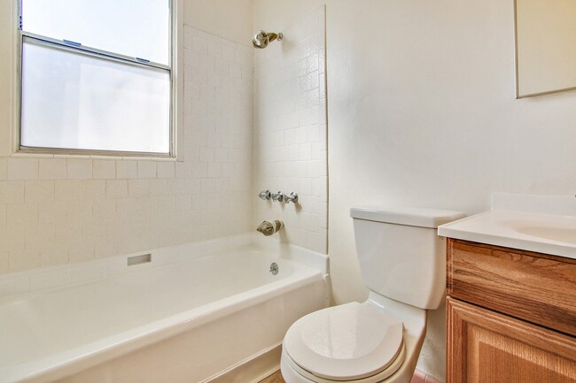 Bathroom With Tub and Shower Combo, Wood Style Flooring - Banner Circle Apartments