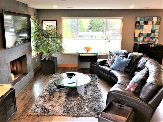 Living room, picture windows, surround sound ceiling speakers, French doors to deck - 6549 40th Ave NE