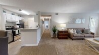 Located at Chace Lake in Hoover, Alabama, this single-floor residence offers a thoughtfully arranged layout designed for comfortable everyday living. The open-concept living area is a welcoming focal point, featuring plush carpeting, a ceiling fan, large bay windows that invite natural light, and a tiled fireplace that adds warmth and character to the space. Adjacent to the living room, the galley-style kitchen is well-equipped with stainless steel appliances, grey cabinetry, a double sink, and durable wood-look flooring that extends into the dedicated dining area — an intimate space perfect for seated meals. A versatile office provides a quiet retreat with a window overlooking greenery, carpet flooring, and a ceiling fan. The bedroom is comfortably sized with a natural light source and soft carpet underfoot, complemented by two closets offering ample storage. The bathroom features a vanity with granite-style countertops, grey cabinetry, and wood-look flooring. Practical conveniences include an in-unit laundry area with washer and dryer hookups and built-in shelving. Throughout the residence, neutral tones and textured ceilings create a cohesive, understated aesthetic.