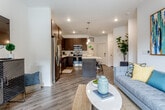 Located at 4401 Pennsylvania Ave in Kansas City, MO, this single-floor residence offers a thoughtfully designed open-concept layout that seamlessly connects the kitchen, dining, and living areas. Rich hardwood-style flooring runs throughout the main living spaces, complementing a neutral color palette that creates a bright, contemporary atmosphere.

The kitchen is a standout feature, showcasing dark espresso cabinetry extending to the ceiling, white quartz countertops, a decorative tile backsplash, and a full suite of stainless steel appliances. A central island with pendant lighting above provides additional prep space and casual seating, flowing naturally into the living area. The living room benefits from a ceiling fan, recessed lighting, and sliding glass doors that open to a private balcony with outdoor views.

The bedroom is generously proportioned, featuring plush carpeting, a ceiling fan, and sliding glass door access to the balcony, filling the room with natural light. The bathroom includes a soaking tub with shower, a dark-cabinetry vanity with quartz countertops, and direct access to a dedicated in-unit laundry area equipped with a full-size washer and dryer. The overall ambiance is modern, clean, and well-appointed throughout.