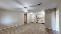 Located at 100 Crestwood Dr in Beebe, Arkansas, this single-floor, 2-bedroom, 2-bathroom home offers a practical and comfortable layout. The open-concept living and dining area is anchored by a ceiling fan with light fixture and features a combination of plush carpeting in the living zone and smooth vinyl plank flooring flowing into the kitchen. Neutral-toned walls throughout give the space a clean, versatile look.

The kitchen is well-equipped with white appliances including a dishwasher, electric range, and refrigerator, complemented by warm wood-trimmed white cabinetry, a double-basin sink, and ample counter space arranged in an L-shaped configuration. A dedicated dining area sits adjacent, and a utility room provides additional functional space.

Both bedrooms are carpeted for comfort, with the primary bedroom offering a dedicated closet and a ceiling fan. Natural light filters through window blinds in the bedrooms, lending a bright feel. The home includes three closets total, providing generous storage. Both bathrooms feature tub-shower combinations with white tile surrounds. A connecting hallway ties the private areas of the home together efficiently, creating a well-organized and livable floor plan.
