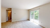 Located at 2336 Cowan Blvd in Fredericksburg, Virginia, this three-bedroom, two-bathroom residence offers a thoughtfully arranged single-level floor plan with a comfortable and functional layout. Neutral tones, plush carpeting, and clean white trim carry throughout the space, creating a bright and cohesive ambiance.

The living room is a standout area, featuring sliding glass doors that open directly onto a private balcony overlooking lush, mature greenery — filling the room with natural light and peaceful outdoor views. An adjacent dining room provides a dedicated space for meals, while the kitchen is equipped with warm wood cabinetry, granite-style countertops, a stainless steel sink, and full appliances including a range and refrigerator, all set on easy-care hardwood-style flooring.

The three bedrooms are generously sized and carpeted, each offering a quiet retreat. The primary bedroom is notably spacious, and multiple rooms feature dedicated closet space — with an impressive seven closets total throughout the home. The two bathrooms are well-appointed with granite-style vanity tops and wood cabinetry. A dedicated laundry area adds everyday convenience. Two hallways connect the layout seamlessly, rounding out this well-equipped residence.