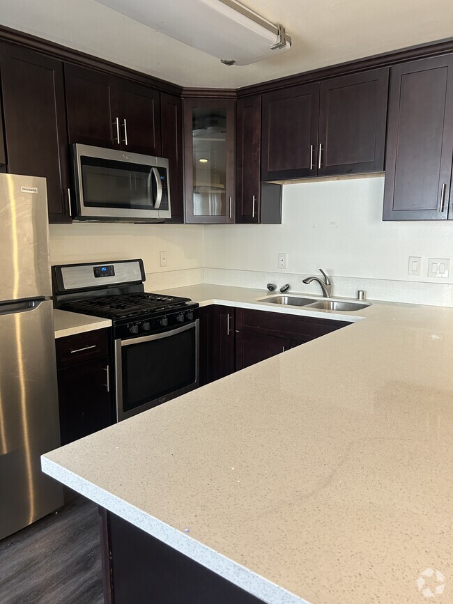 Upgraded Gourmet kitchen with stainless steel appliances and quartz countertops - 278 E Washington Blvd