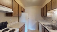 Located at 1700 Bob-O-Link Bnd in Columbus, Ohio, this single-floor residence offers a functional and comfortable layout designed for everyday living. The galley-style kitchen is thoughtfully arranged with warm medium-toned wood cabinetry lining both walls, light-colored laminate countertops, and a full suite of white appliances including a refrigerator, electric range, and dishwasher. Tile flooring completes the kitchen's clean, practical aesthetic. The living area is generously sized, featuring plush wall-to-wall carpeting and neutral beige walls that create a warm, welcoming atmosphere. A sliding glass door fitted with vertical blinds allows natural light to fill the room and provides access to an outdoor area. The bedroom is carpeted and well-proportioned, with a window offering views to the exterior and a textured ceiling that adds subtle visual interest. The full bathroom includes a tiled tub-shower combination, a toilet, and a vanity with countertop storage, all set on tile flooring that ties the space together neatly. Throughout the unit, a consistent neutral color palette and clean lines contribute to a cohesive, move-in-ready feel.