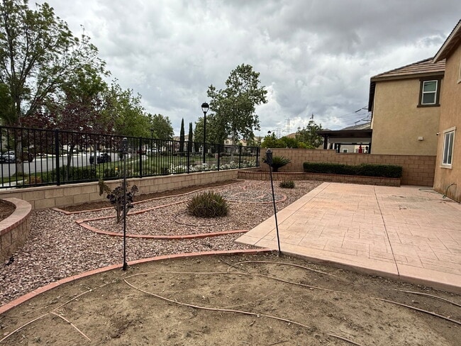 Photo - New flooring & paint!  Large backyard - landscaped and ready for garden!   Community pool, fitnes... Apartment