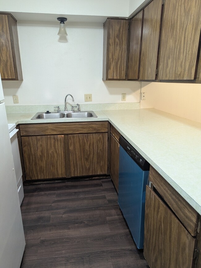 kitchen with range, dishwasher, refrigerator, and disposal - 1800 Romack Ct
