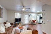 Located at 400 Southwest Pkwy in College Station, TX, this single-story, 4-bedroom, 2-bathroom unit offers a well-designed layout that maximizes functionality across its floor plan. The open-concept living, dining, and kitchen area serves as the heart of the home, featuring warm hardwood-style flooring, a ceiling fan with light fixture, and multiple windows that invite natural light throughout. The kitchen is equipped with stainless steel appliances — including a refrigerator, range, microwave, and dishwasher — paired with ample white cabinetry, a double sink, and generous counter space. A skylight brightens the kitchen and dining area further. Each of the four bedrooms features carpeted flooring, a ceiling fan, a dedicated closet with sliding or hinged doors, and a window allowing natural light. The bedrooms are well-suited for study and rest, with enough space for a bed, dresser, and desk. The two full bathrooms include a tub-shower combination with white tile surround and a vanity with extended countertop and cabinet storage, finished with hardwood-style flooring. A dedicated in-unit laundry room houses a full-size washer and dryer. Additional highlights include seven closets for generous storage and a private patio for outdoor use.