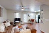 Located at 400 Southwest Pkwy in College Station, TX, this single-story, 4-bedroom, 2-bathroom unit offers a well-designed layout that maximizes functionality across its floor plan. The open-concept living, dining, and kitchen area serves as the heart of the home, featuring warm hardwood-style flooring, a ceiling fan with light fixture, and multiple windows that invite natural light throughout. The kitchen is equipped with stainless steel appliances — including a refrigerator, range, microwave, and dishwasher — paired with ample white cabinetry, a double sink, and generous counter space. A skylight brightens the kitchen and dining area further. Each of the four bedrooms features carpeted flooring, a ceiling fan, a dedicated closet with sliding or hinged doors, and a window allowing natural light. The bedrooms are well-suited for study and rest, with enough space for a bed, dresser, and desk. The two full bathrooms include a tub-shower combination with white tile surround and a vanity with extended countertop and cabinet storage, finished with hardwood-style flooring. A dedicated in-unit laundry room houses a full-size washer and dryer. Additional highlights include seven closets for generous storage and a private patio for outdoor use.