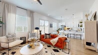 Located in Phoenix, AZ, this single-story home offers a thoughtfully designed open-concept layout across three bedrooms and three bathrooms. Light wood-tone flooring flows throughout the main living areas, complemented by crisp white walls and abundant natural light streaming through multiple windows with plantation-style blinds.

The living room serves as the heart of the home, featuring a ceiling fan, recessed lighting, and a sliding glass door that opens to the outdoors. It connects seamlessly to the kitchen, which is outfitted with white cabinetry, white quartz countertops, stainless steel appliances, a large refrigerator, and pendant lighting over a breakfast bar — ideal for both everyday living and entertaining.

The primary bedroom is a generous and serene retreat, featuring hardwood-style flooring, tall ceilings, soft natural light, and direct access to a walk-in closet with built-in shelving and hanging rods. Each additional bedroom is well-proportioned and filled with natural light, offering comfort and versatility.

The bathrooms feature clean, contemporary finishes, including stylish mirrors and modern fixtures. A dedicated laundry room with full-size washer and dryer connections and built-in shelving adds everyday convenience. Hallways connecting the rooms are wide and welcoming, reinforcing the home's open and functional flow throughout.