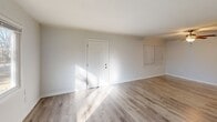Located at 1720 Van Heise St in Columbia, SC, this single-story 3-bedroom, 1-bathroom home offers a clean, updated interior with a cohesive design throughout. Light-toned luxury vinyl plank flooring runs throughout the home, providing both durability and a modern aesthetic that brightens each room.

The combined kitchen and living room area anchors the home's layout. The galley-style kitchen is well-appointed with warm wood cabinetry, ample upper and lower storage, a double sink, and black appliances including a gas range, over-the-range microwave, and refrigerator. The open living room adjacent to the kitchen offers generous space and is bathed in natural light.

Each of the three bedrooms features the same stylish flooring, crisp white walls, and six-panel white doors. Two bedrooms are equipped with ceiling fans with light fixtures and large sliding windows that invite natural light and views of surrounding greenery. The spacious primary bedroom offers generous proportions and closet access. The full bathroom is outfitted with a tub/shower combination featuring a sleek white surround with built-in shelving and brushed gold fixtures, adding a refined touch. A hallway connects the bedrooms and bathroom, contributing to a practical and efficient floor plan throughout this well-maintained home.
