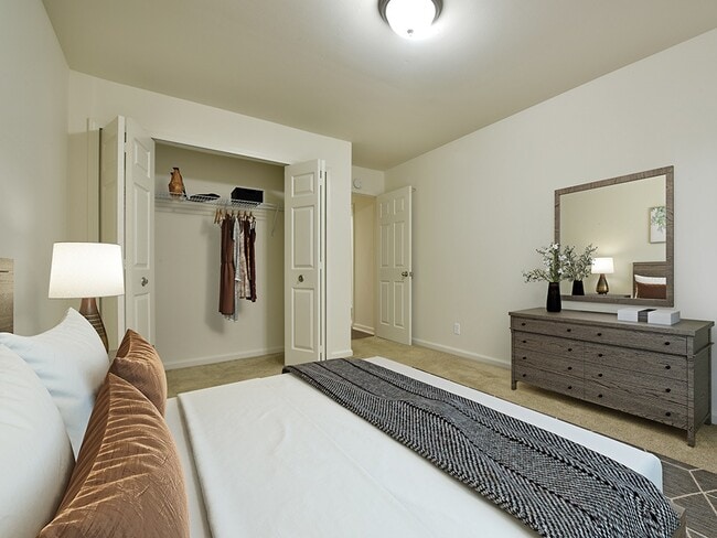A large bedroom with a closet. - Grand Bend Club Apartments