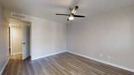 Located at 225 N Gilbert Rd in Mesa, AZ, this two-story home offers 2 bedrooms and 4 bathrooms across two well-appointed floors. The main level provides a generous living area and a fully updated kitchen featuring white shaker cabinetry, grey quartz-style countertops, a classic subway tile backsplash, and a complete suite of stainless steel appliances including a refrigerator, range, microwave, and dishwasher. A dining nook adjacent to the kitchen benefits from natural light through a large window with blinds. Light-toned luxury vinyl plank flooring flows consistently throughout the home, complementing the clean, neutral color palette. The staircase leads to the upper level, where vaulted ceilings lend an open, airy feel to the living spaces. The spacious primary bedroom features a ceiling fan with light fixture and its own dedicated bathroom access. Additional bedrooms also benefit from vaulted ceilings, ceiling fans, and natural light. The four bathrooms are cleanly finished with white tile tub-and-shower combinations, wood-look flooring, and select bathrooms featuring updated vanities with framed mirrors and contemporary lighting. Two closets provide practical storage throughout the home.