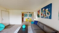 Located at 7100 E Mississippi Ave in Denver, Colorado, this single-floor unit offers a well-organized and functional layout. The living room serves as the heart of the home, featuring plush carpeting, a textured ceiling, and a large sliding glass door that opens to a private balcony, allowing natural light to fill the space. A wall-mounted air conditioning unit provides year-round comfort. The living area flows seamlessly into a dedicated dining nook, which is separated by an open passthrough and benefits from its own ceiling fan. The kitchen is thoughtfully designed with warm wood cabinetry, dark granite-style countertops, a double stainless steel sink, and durable wood-look flooring — offering ample storage and prep space. The bedroom is a comfortable retreat, carpeted throughout, with a generously sized closet featuring built-in shelving and hanging space, as well as a large window dressed with blinds that allows for natural light. The full bathroom is well-appointed with wood vanity cabinetry, dark countertops, a wide mirror, and a shower-tub combination. Throughout the unit, textured ceilings and neutral wall tones provide a clean, versatile backdrop suitable for a variety of interior styles.