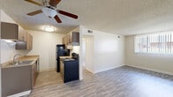 Located at 4372 Montebello Dr in Colorado Springs, CO, this one-bedroom, one-bathroom unit offers a thoughtfully arranged single-floor layout. The open-plan living and dining area is bright and airy, featuring durable laminate wood-style flooring and a ceiling fan with light fixture. Large windows dressed with vertical blinds allow natural light to fill the space and offer views of the surrounding community. The galley-style kitchen is efficiently designed with dual-basin sink, ample upper and lower cabinetry in warm wood tones, laminate countertops, and black appliances including a refrigerator and an electric range with hood. A textured ceiling is consistent throughout the unit, adding a classic residential character. The bedroom is comfortably sized, finished with plush carpet flooring and natural light from a window with blinds. It includes dual sliding-door closets, providing generous storage. An additional closet is accessible from the hallway, further enhancing storage options. The bathroom features a full tub/shower combo with white tile surround. A utility room and dedicated hallway complete the functional layout of this well-organized Colorado Springs residence.