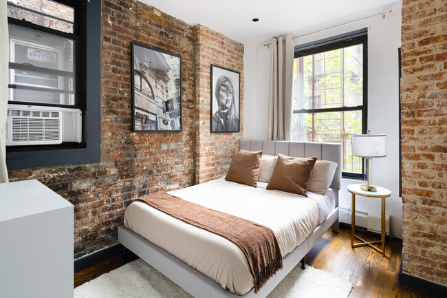 The bedroom features a premium quality mattress - Stylish 3/4BD Apartments (+Rooftop&Backyard)