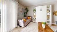 Located at 2886 S Circle Dr in Colorado Springs, CO, this efficiently designed single-floor unit makes excellent use of its compact footprint. The open living area is bathed in natural light streaming through large sliding glass doors fitted with vertical blinds, leading out to a private patio. Light wood-tone flooring, neutral warm-gray walls, and a textured ceiling create an inviting, cohesive atmosphere throughout.

The living space is thoughtfully arranged to maximize functionality, featuring a built-in Murphy bed unit with integrated open shelving — an ideal space-saving solution. The kitchen is a standout, showcasing white shaker cabinetry, granite countertops, a sleek gray subway tile backsplash, stainless steel appliances, and wood-toned flooring that ties seamlessly into the main living area.

The hallway connects the living space to the two bathrooms, which feature large-format tile flooring and distinctive decorative details, including a striking cluster of gold-framed circular mirrors. A glass-enclosed shower area adds a modern touch. A dedicated closet provides practical storage.

The unit's layout is completed by an outdoor patio, offering a private outdoor retreat. Overall, the space strikes a balance between compact efficiency and stylish, modern living.