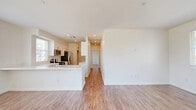 Located at 14951 Foothill Blvd in Fontana, CA, this well-designed two-bedroom, two-bathroom residence offers a thoughtfully organized single-floor layout. Wood-look flooring flows consistently throughout the space, lending warmth and visual continuity to every room.

The open-concept living and dining area is bright and airy, with recessed lighting and a sliding glass door that connects directly to a private balcony, allowing natural light to fill the space and providing outdoor views of the surrounding neighborhood.

The kitchen is designed for functionality, featuring white shaker cabinetry with brushed nickel hardware, light quartz countertops, a double-basin sink, and a full suite of stainless steel appliances including a gas range, microwave, dishwasher, and refrigerator. Ample upper and lower cabinetry provides generous storage throughout.

Both bedrooms are comfortably sized, with the primary bedroom offering dedicated closet space. The second bedroom includes a ceiling fan and a window with neighborhood views. Each room is finished with clean white walls and consistent flooring.

The two bathrooms are finished in a clean, modern style with white cabinetry, white countertops, and tub-shower combinations. Each bathroom also includes a window for natural ventilation. Two closets provide additional storage throughout the home.