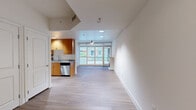 Located at 1455 Kettner Boulevard in San Diego's vibrant Little Italy neighborhood, this thoughtfully designed one-bedroom, three-bathroom residence offers a generous and well-appointed single-floor layout. The open-concept living and kitchen areas are anchored by wood-look tile flooring, recessed lighting, and floor-to-ceiling sliding glass doors that flood the space with natural light and provide direct access to a private balcony overlooking the surrounding neighborhood. The living area features a ceiling fan and a built-in fireplace, adding both comfort and character.

The kitchen is well-equipped with warm honey-toned cabinetry, granite countertops, stainless steel appliances including a refrigerator and dishwasher, and a double sink—all complemented by recessed lighting overhead. The spacious primary bedroom is carpeted, features mirrored closet doors, and is lined with expansive floor-to-ceiling windows that invite abundant natural light. Three full bathrooms serve the residence: one features a tiled walk-in shower, another offers a soaking tub and tub-shower combination, and the primary bath includes a dual-sink vanity with granite countertops, a separate shower, and wood-look tile flooring. Four closets provide ample storage throughout.