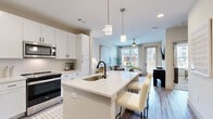 Located at 257 Indian Lake Blvd in Hendersonville, Tennessee, this thoughtfully designed one-bedroom, one-bathroom residence offers a comfortable and modern living experience across a single floor. The open-concept layout seamlessly connects the kitchen and living room, creating an inviting and functional space.

The kitchen is a standout feature, showcasing white shaker cabinetry with matte black hardware, a white quartz countertop island with a black undermount sink and bar seating, stainless steel appliances, and a classic subway tile backsplash. Pendant lighting adds a refined touch overhead. The living room receives abundant natural light through large windows and a glass door, and is finished with wood-look flooring and a ceiling fan.

The bedroom is a calm retreat with a large window framing outdoor views, a ceiling fan, and warm neutral tones. It includes a walk-in closet outfitted with wire shelving and hanging rods for organized storage. The bathroom features a white vanity with ample cabinetry, a well-lit mirror, and light wood-look flooring that carries through the hallway. A dedicated laundry area adds everyday convenience. The overall ambiance is clean, bright, and contemporary throughout.