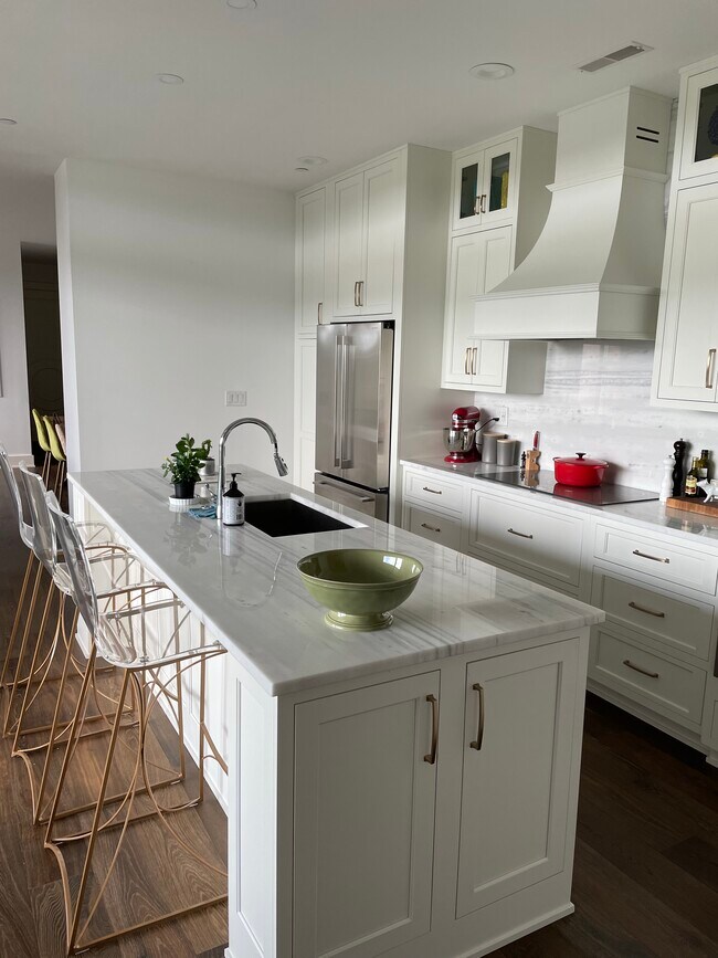 Bar stools so guest can keep you company while you fix dinner. - 6600 Seminary Woods Plz