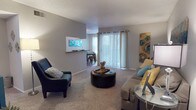 Located at 3634 Tupelo Ln in San Antonio, TX, this single-floor unit offers a well-organized and comfortable layout ideal for everyday living. The living room serves as the heart of the home, featuring plush wall-to-wall carpeting, neutral gray walls, and a textured ceiling. Large sliding glass doors flood the space with natural light and provide access to the outdoors, while a pass-through opening connects seamlessly to the dining and kitchen areas, creating an open and connected feel. The galley-style kitchen is efficiently designed with rich dark wood cabinetry, ample counter space, wood-look flooring, and a full suite of appliances including a range and refrigerator. Adjacent to the kitchen, the dedicated dining area is bright and inviting, featuring wood-look flooring, large windows with sheer curtains, and enough space for a full dining table and chairs. The bedroom is a restful retreat with soft carpeting, a ceiling fan with light fixture, and a calm, neutral color palette. The bathroom features a full tub-shower combination with clean white tile surround and wood-look flooring. Throughout the unit, a consistent teal and yellow accent color scheme lends a cohesive, welcoming ambiance.