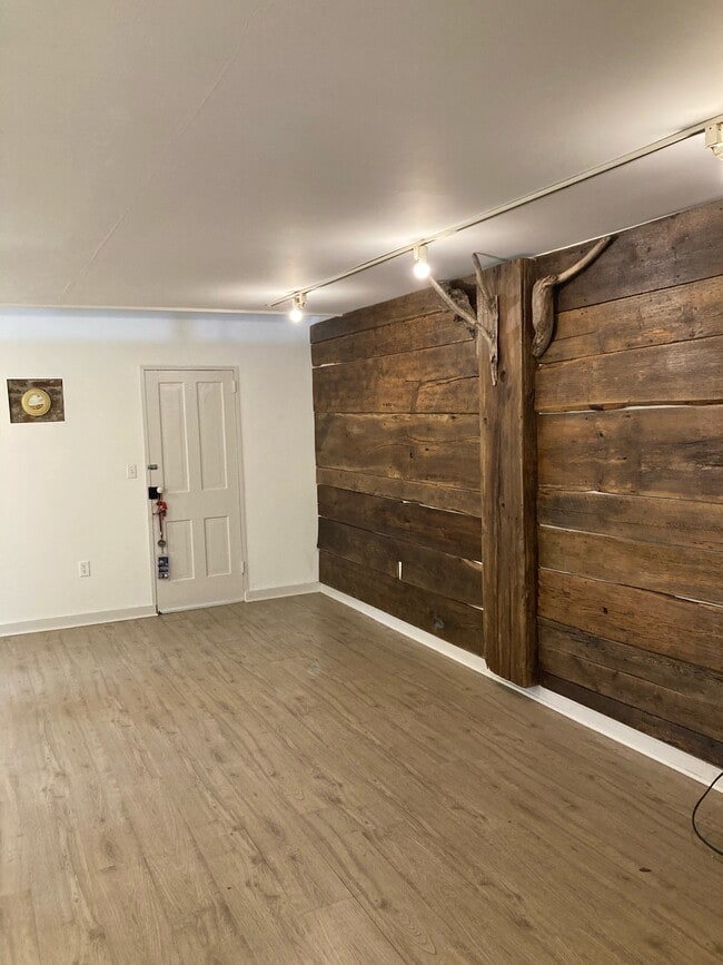 Custom barn-wood accent wall in living room. - 26622 Medders Rd