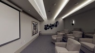 This private movie theater is designed to deliver an upscale cinematic experience within a refined, modern setting. The single-level space is arranged with tiered rows of generously sized, tufted lounge chairs upholstered in soft neutral fabric, ensuring comfortable sightlines to the large retractable projection screen positioned at the front of the room. A ceiling-mounted projector provides a high-quality viewing experience, while the room's layout accommodates a generous number of guests across multiple elevated rows.

The interior design follows a cohesive gray palette, with soft carpeted floors, neutral-toned walls, and a coffered ceiling featuring elegant recessed LED strip lighting that runs the length of the room, casting a warm, ambient glow. Sleek black wall sconces are symmetrically placed along the rear and side walls, contributing to the intimate theater atmosphere.

Distinctive decorative elements include a striking large-scale owl portrait artwork displayed as a diptych near the screen, complemented by a curated arrangement of dark circular wall sculptures in varying sizes. A smart control panel near the entrance allows for convenient management of the room's systems, and the space is accessible through a dedicated doorway, reinforcing its function as a self-contained, purpose-built screening room.