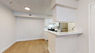 Located at 6131 N 27th Ave in Phoenix, AZ, this one-bedroom, one-bathroom unit offers a well-organized single-floor layout designed for comfortable everyday living. The living room is bright and open, featuring light wood-style flooring, neutral walls, a textured ceiling, and a sliding glass door fitted with vertical blinds that allows natural light to fill the space. The kitchen is efficiently designed in a galley-style configuration, showcasing white shaker cabinets, white countertops, and stainless steel appliances including an electric range and refrigerator. A pass-through breakfast bar connects the kitchen to the living area, creating an open and functional flow. An in-unit washer is also present within the kitchen area, adding everyday convenience. The bedroom is a comfortable, private retreat with light flooring, neutral tones, a textured ceiling, and a window with blinds providing natural light. A dedicated closet offers organized storage. The bathroom features a full bathtub and shower combination with clean white finishes and light flooring. Throughout the unit, consistent light wood-style flooring and a crisp white-and-neutral palette create a clean, cohesive aesthetic well-suited for Phoenix living.