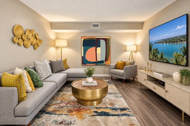 Step into comfort at Club Mira Lago. This inviting living space features modern furnishings, warm lighting, and elegant décor, creating the perfect atmosphere for relaxation. See yourself here—schedule a tour today! - Club Mira Lago Apartments