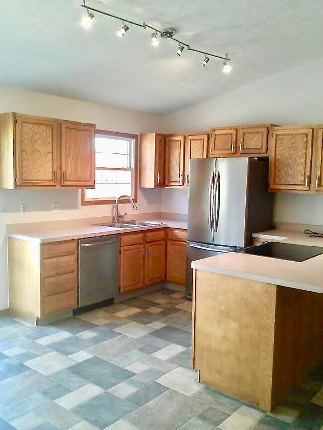 Spacious kitchen. High end stainless appliances, vaulted ceiling, open to living area. - 778 A Calderwood Court