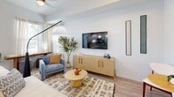 Located at 825 32nd Ave S in Saint Petersburg, FL, this single-floor, 2-bedroom, 2-bathroom home offers a thoughtfully designed layout with modern finishes throughout. Light wood-tone flooring flows seamlessly across the entire space, complemented by a bright, neutral color palette that enhances the sense of openness.

The welcoming entryway features recessed lighting and leads into a combined kitchen and living area. The kitchen is outfitted with crisp white shaker cabinets, granite countertops, stainless steel appliances, and a central island with bar seating beneath pendant lights — ideal for both cooking and casual dining. The adjacent living room benefits from large windows that invite generous natural light, with a ceiling fan adding comfort.

The primary bedroom offers a comfortable, well-proportioned retreat with natural light from a large window, a ceiling fan, and direct access to its own bathroom. The en-suite bathroom features white cabinetry, granite countertops, and tile work. A dedicated walk-in closet provides organized storage with built-in shelving and hanging rods. The second bedroom is equally bright with a soft, airy ambiance. Both bathrooms maintain a consistent, clean aesthetic. The space also includes a dedicated closet for additional storage.