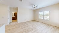 This contemporary 1-bedroom apartment in Seagoville, TX offers 980 square feet of thoughtfully designed living space. The open-concept floor plan seamlessly integrates the kitchen, living, and dining areas, creating a spacious and airy atmosphere. The kitchen is a highlight, featuring sleek stainless steel appliances, rich wood cabinetry, and a large center island with granite countertops, perfect for meal preparation or casual dining.

The apartment boasts two full bathrooms, both finished with modern fixtures and elegant tile work. The primary bathroom includes a double vanity with ample storage and a luxurious shower. Light wood-look flooring runs throughout the space, complementing the neutral color palette and enhancing the bright, open feel.

The bedroom is generously sized at 130 square feet and includes a ceiling fan for comfort. Large windows in both the bedroom and living area flood the space with natural light and offer pleasant views. Two closets provide abundant storage options.

Additional features include recessed lighting, a private balcony or patio accessible through a glass door, and in-unit laundry facilities. The apartment's clean lines, high-quality finishes, and thoughtful design create a sophisticated and comfortable living environment.