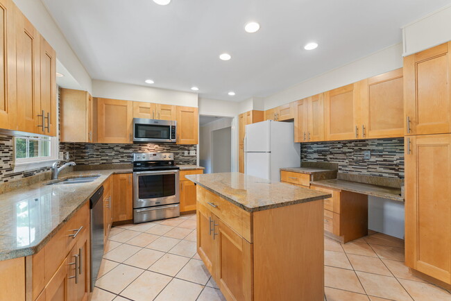 Stainless steel appliances and granite counters featured in gourmet kitchen! - 9 Snug Hill Ct