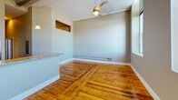 This 920 square foot apartment offers a harmonious blend of modern amenities and classic charm. The open-concept living area seamlessly connects to a well-appointed kitchen, featuring sleek stainless steel appliances, granite countertops, and ample wooden cabinetry. Large windows flood the space with natural light, offering stunning city views and creating an airy ambiance.

The two bedrooms provide comfortable sleeping quarters, with the primary bedroom boasting a generous 180 square feet. Hardwood floors run throughout the apartment, adding warmth and character. The bathroom is efficiently designed, incorporating both functionality and style.

A standout feature is the in-unit laundry, complete with a stacked washer and dryer, enhancing the apartment's convenience. Storage solutions are plentiful, with closets in the bedrooms and hallway.

The apartment's neutral color palette and clean lines create a canvas for personal style. High ceilings and thoughtful lighting fixtures, including pendant lights in the kitchen, contribute to the overall sense of spaciousness.

This well-designed urban dwelling effortlessly combines comfort, style, and practicality, making it an ideal home for modern city living.