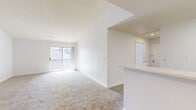 Located at 100 Town Walk Dr in Hamden, Connecticut, this single-floor residence offers a clean, bright, and well-organized layout throughout. The kitchen is outfitted with white shaker-style cabinetry, light stone countertops, and a full suite of stainless steel appliances including a gas range, refrigerator, and dishwasher. Wood-look luxury vinyl flooring runs through the kitchen and connects seamlessly to the open living area, which is carpeted and filled with natural light from a large sliding glass door that opens to a private balcony with outdoor views. The living space is generously proportioned, with a textured ceiling and a crisp white color palette that enhances the sense of openness. The bedrooms are carpeted and well-sized, with one featuring a large window overlooking greenery and another equipped with a spacious closet outfitted with built-in wire shelving for organized storage. The bathroom includes a tiled tub-shower combination with chrome fixtures and wood-look vinyl flooring. A dedicated in-unit laundry area accommodates a full-size washer and dryer side by side. Throughout the residence, clean white walls, neutral tones, and abundant natural light create a calm and functional living environment.